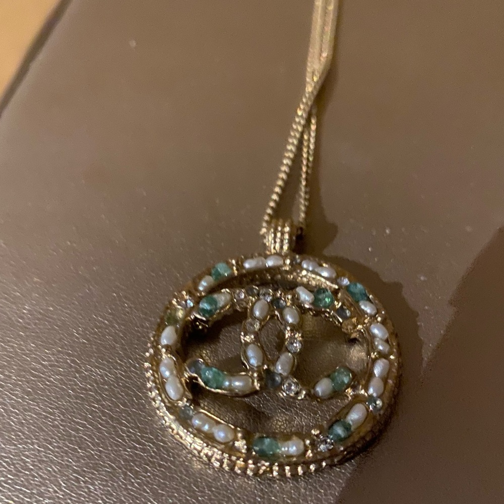 Chanel pendant, yellow hardware with green stones